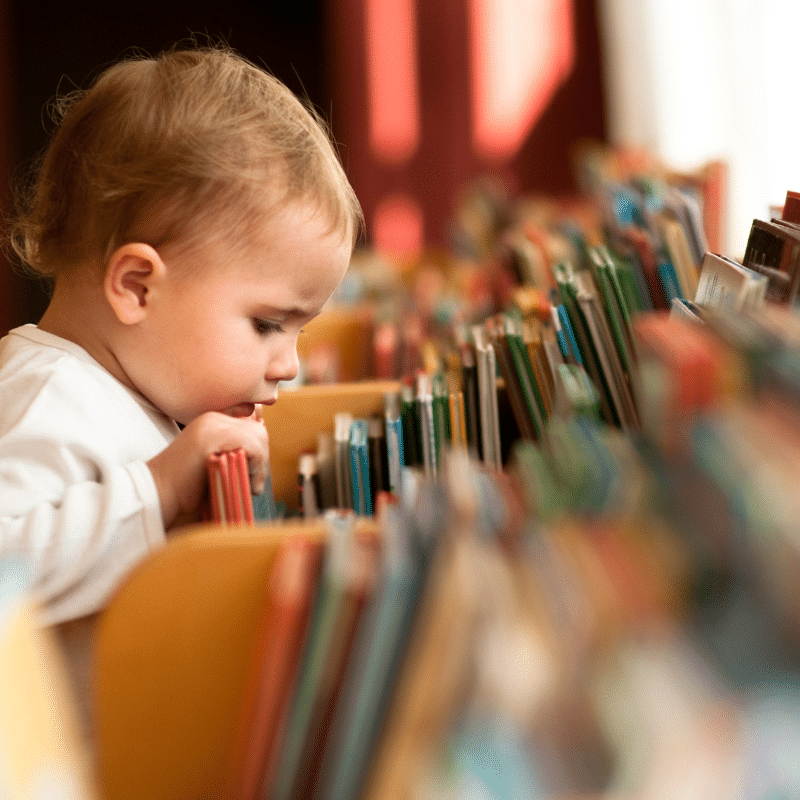 child looking through books